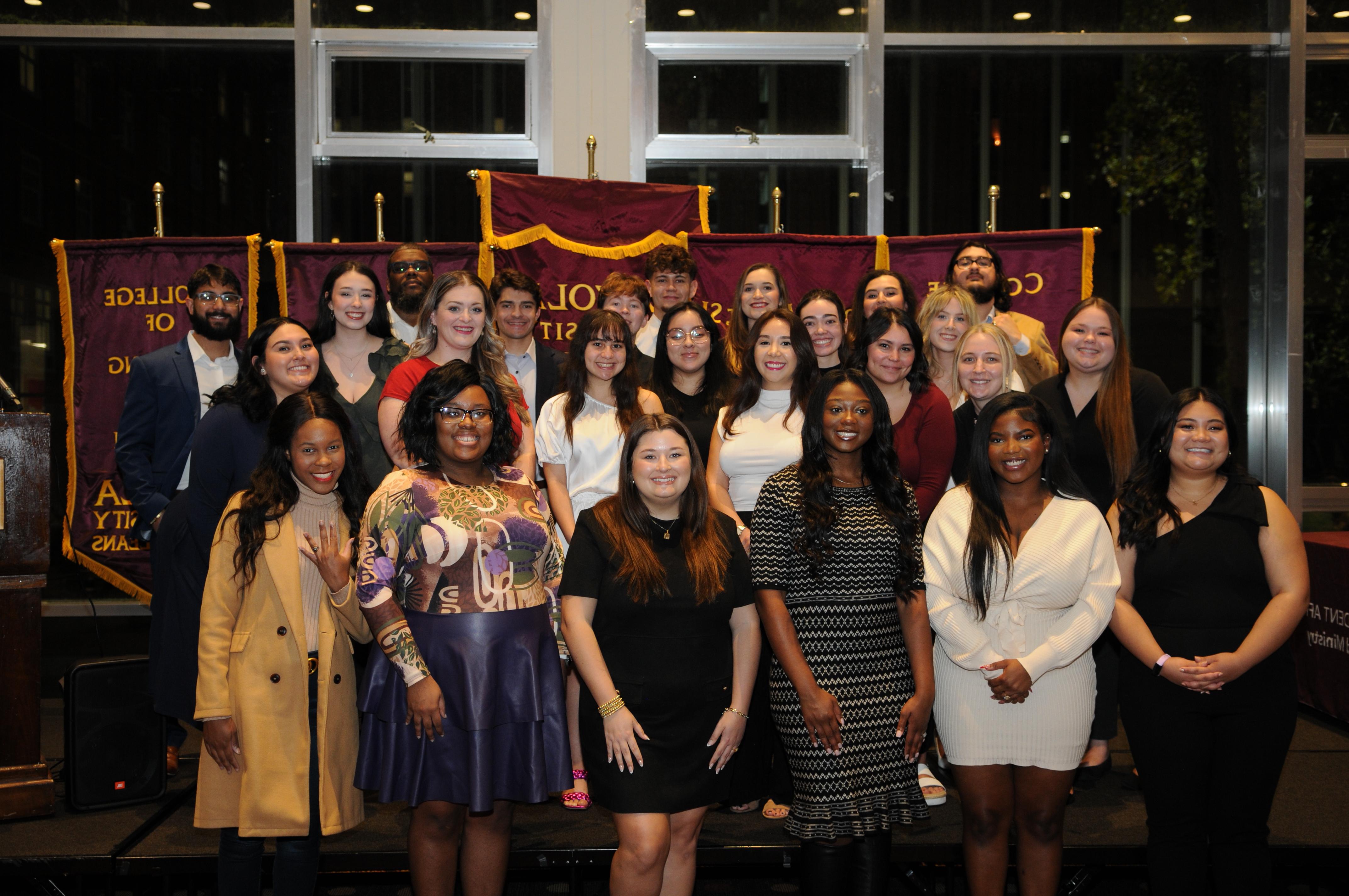 Group of individuals with their class rings. 